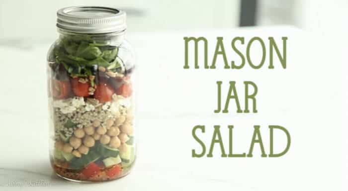 A salad in a jar with text overlay \"Mason Jar Salad.\"