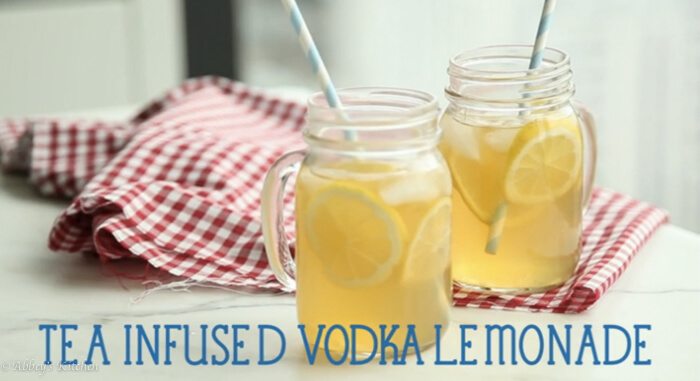 Two glasses filled with tea infused vodka with text overlay \"Tea Infused Vodka Lemonade.\" 