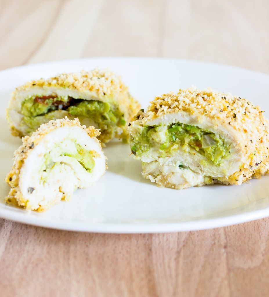 A plate with guacamole stuffed chicken breast.