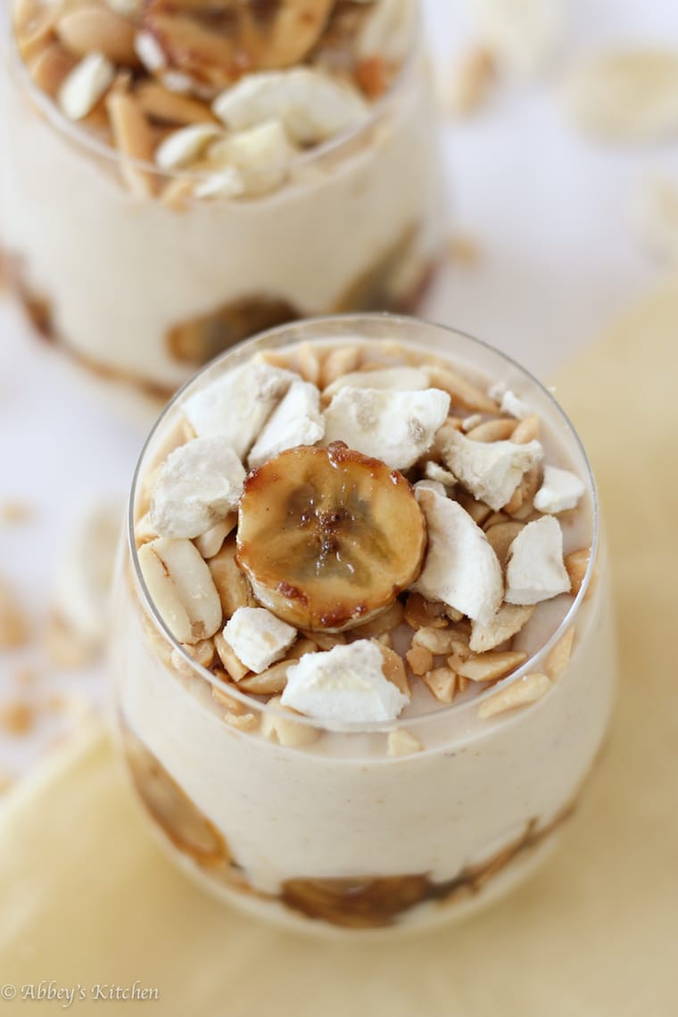 Am overhead photo of a glass of peanut butter banana pudding with banana garnished on top.
