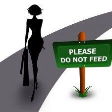 A cartoon of a woman beside a sign "Please Do Not Feed."