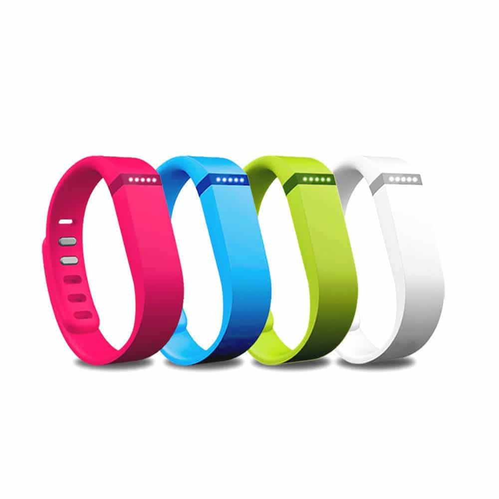Four colourful fitbit smart watches.