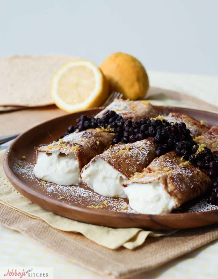 A plate of cheesecake stuffed french toast crepes.