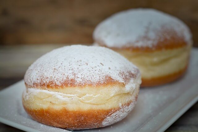 A close up of a powdered donut.