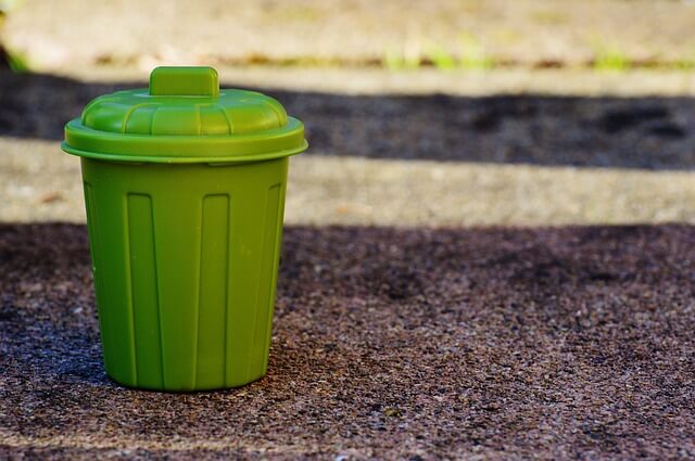 Green garbage on the road.