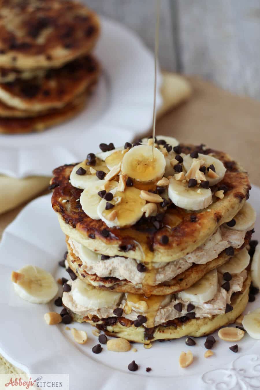 Banana protein pancakes with syrup drizzled over top.