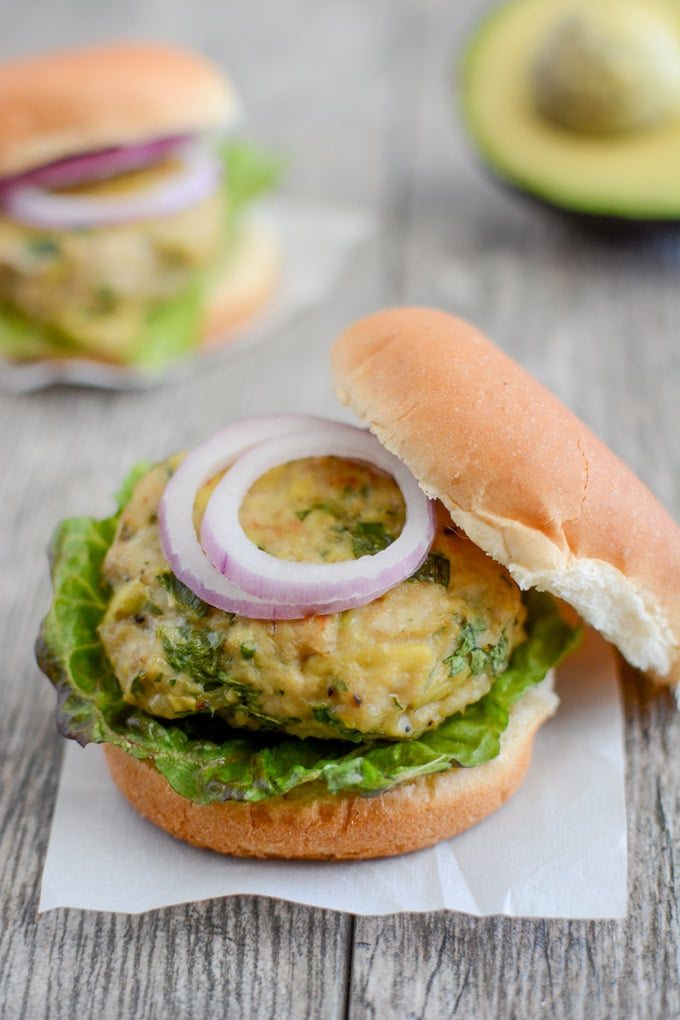 An opened avocado chicken burger.