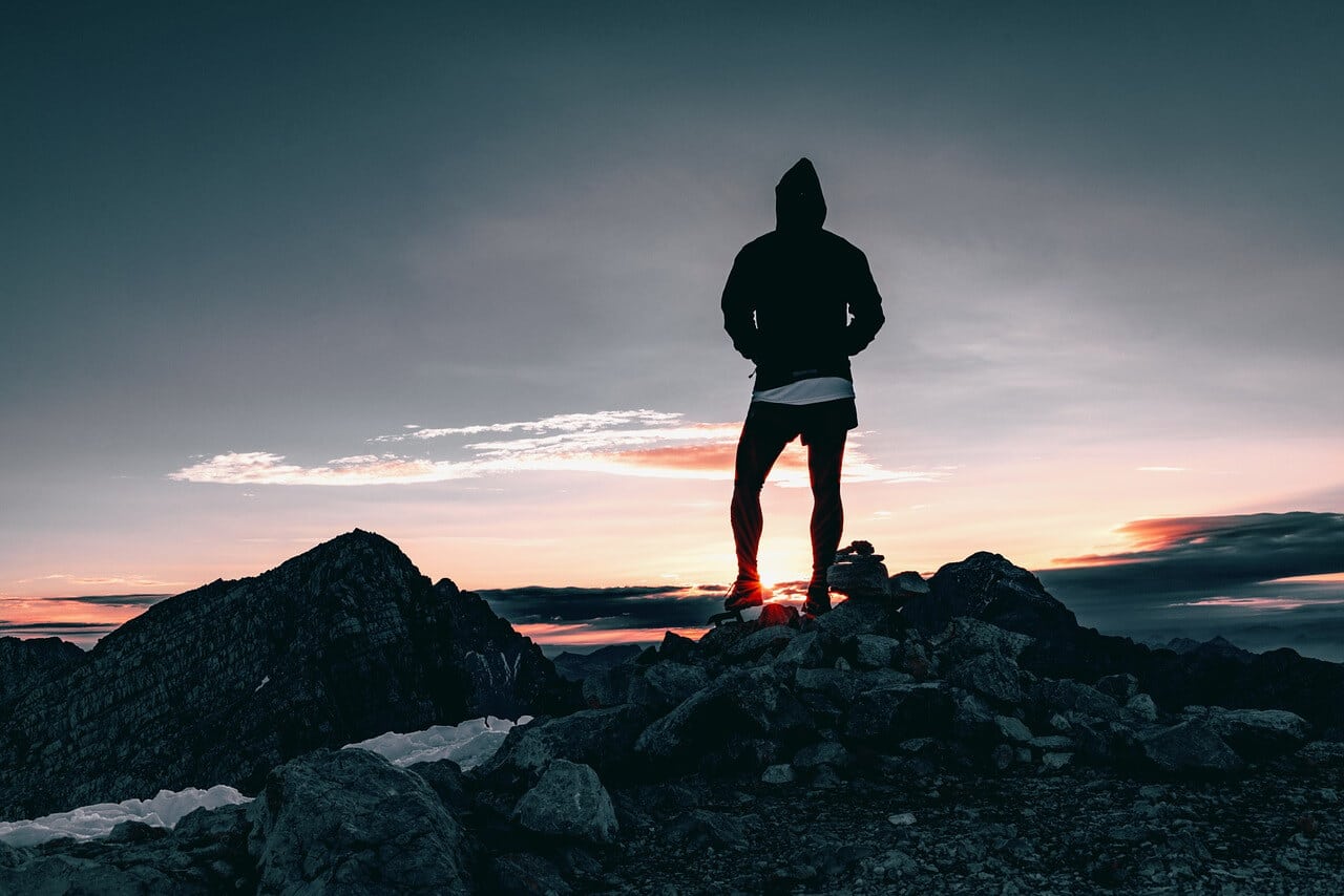 A person standing on top of a mountain.