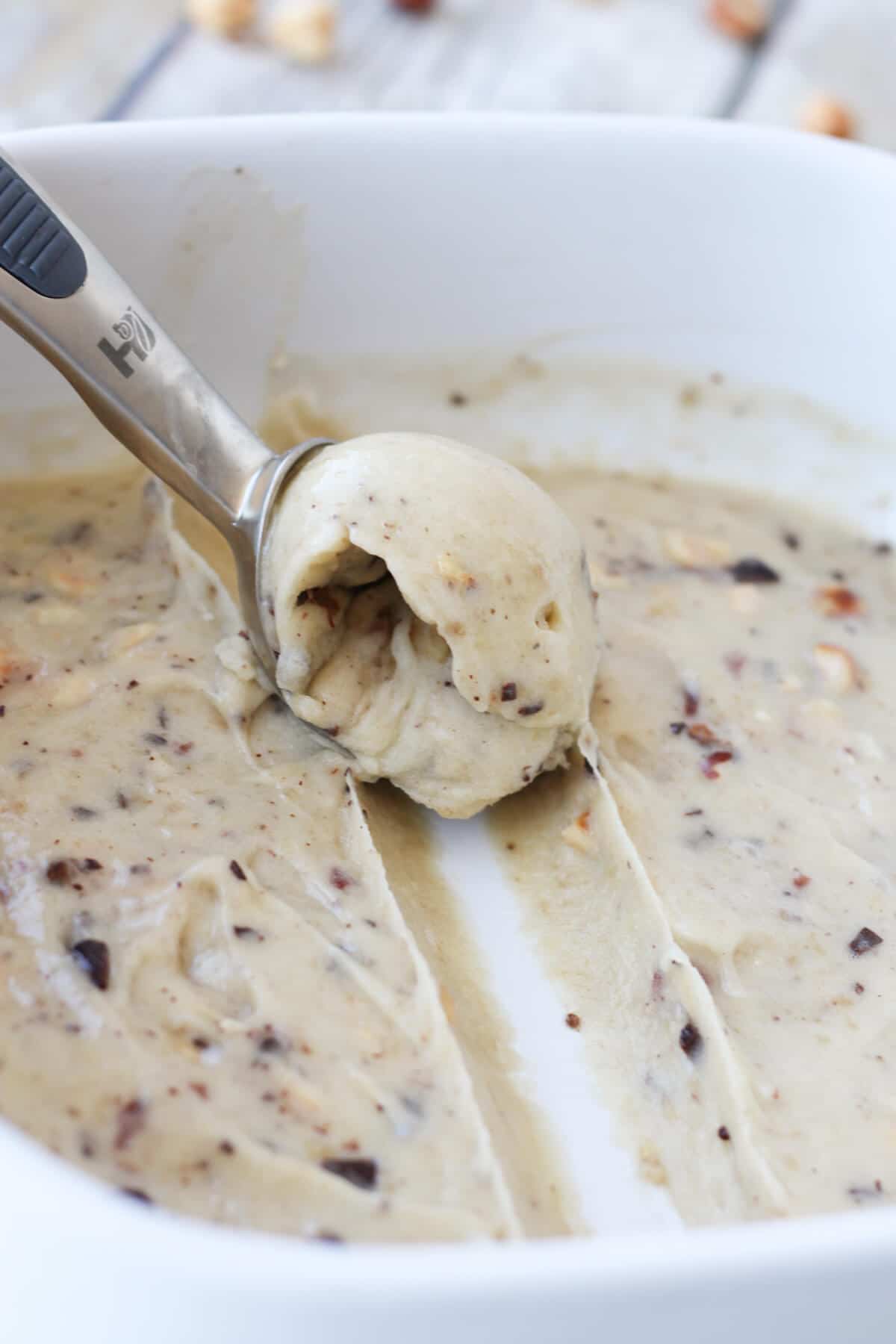 spoon scooping vegan banana nutella ice cream from a bowl