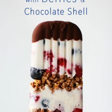 A pinterest image of a popsicle with the text overlay  "Banana Cream Pie Ice Pops with Berries & Chocolate Shell."