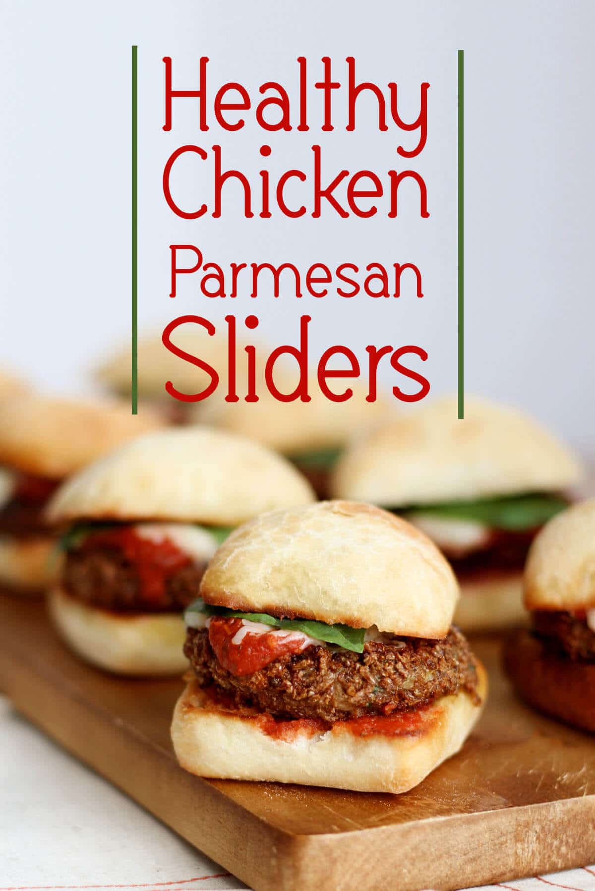 A pinterest image of multiple sliders with the text overlay \"Healthy Chicken Parmesan Sliders.\"