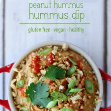 A pinterest image of an overhead photo of dip in a red bowl with the text overlay "THAI peanut hummus dip gluten free - vegan - healthy."