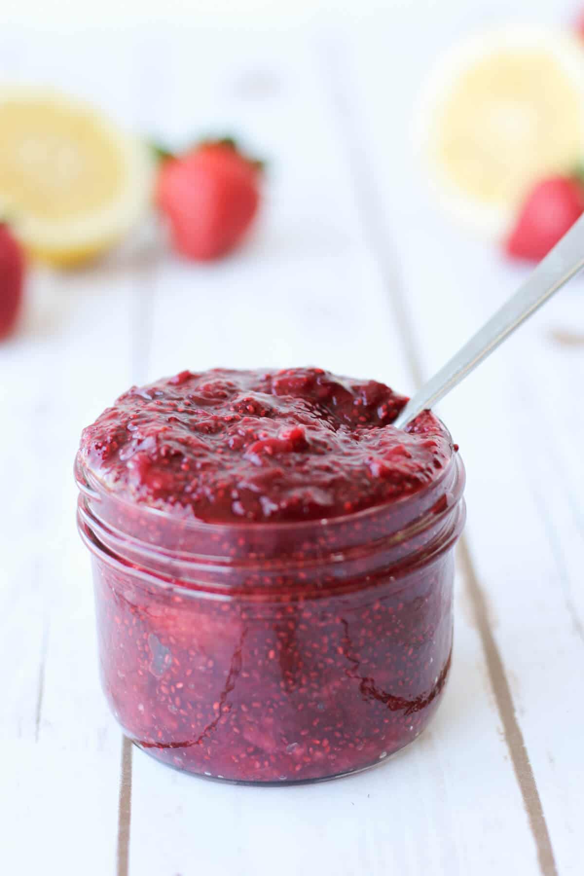 Cherry strawberry chia jam in a small mason jar. 