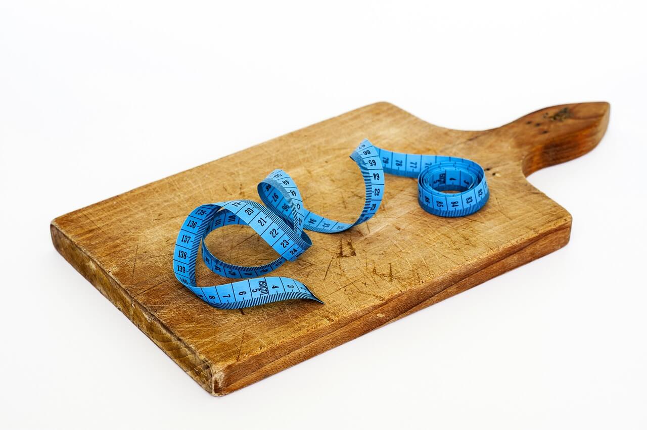 A serving board with measuring tape.