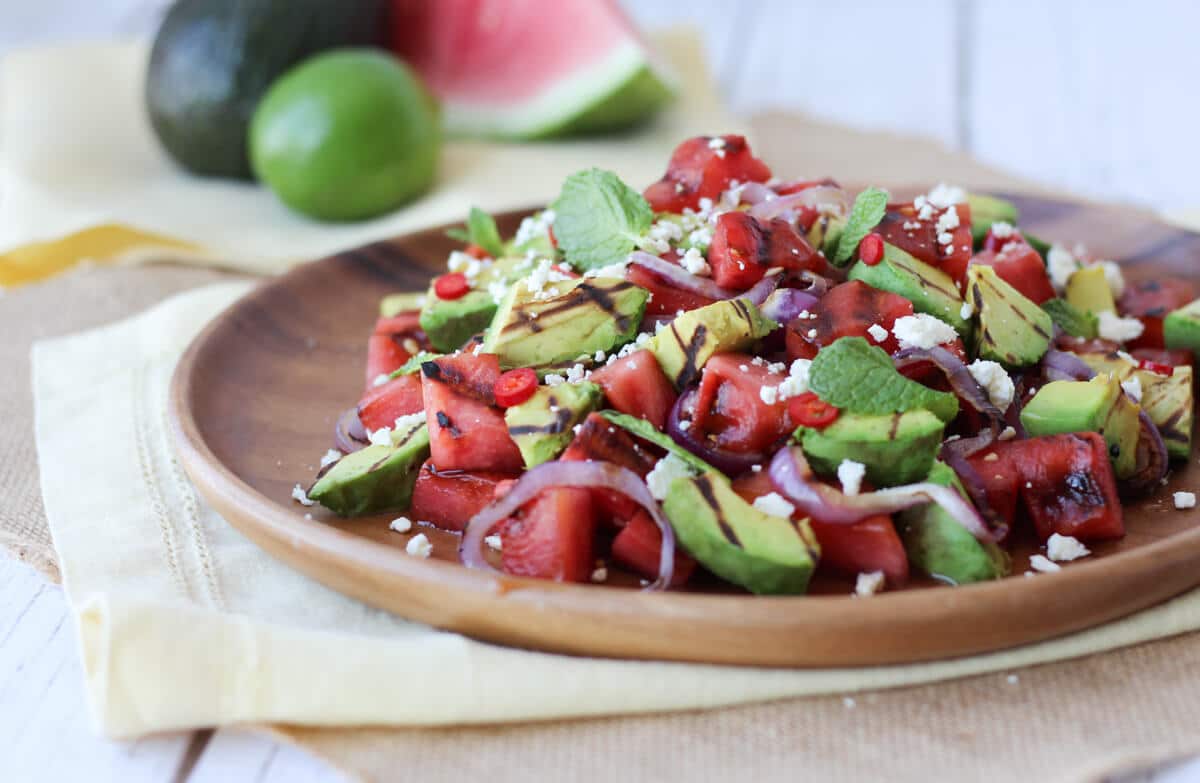 grilled avocado and watermelon salad on a brown plate