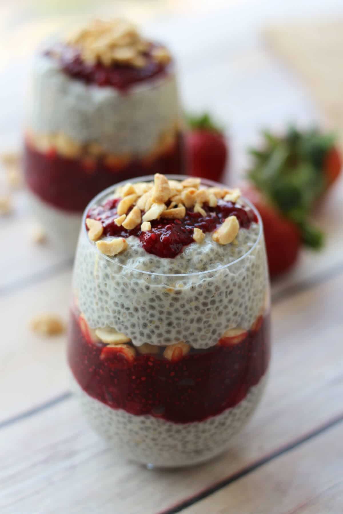 A cup of peanut butter and jam vegan chia pudding.