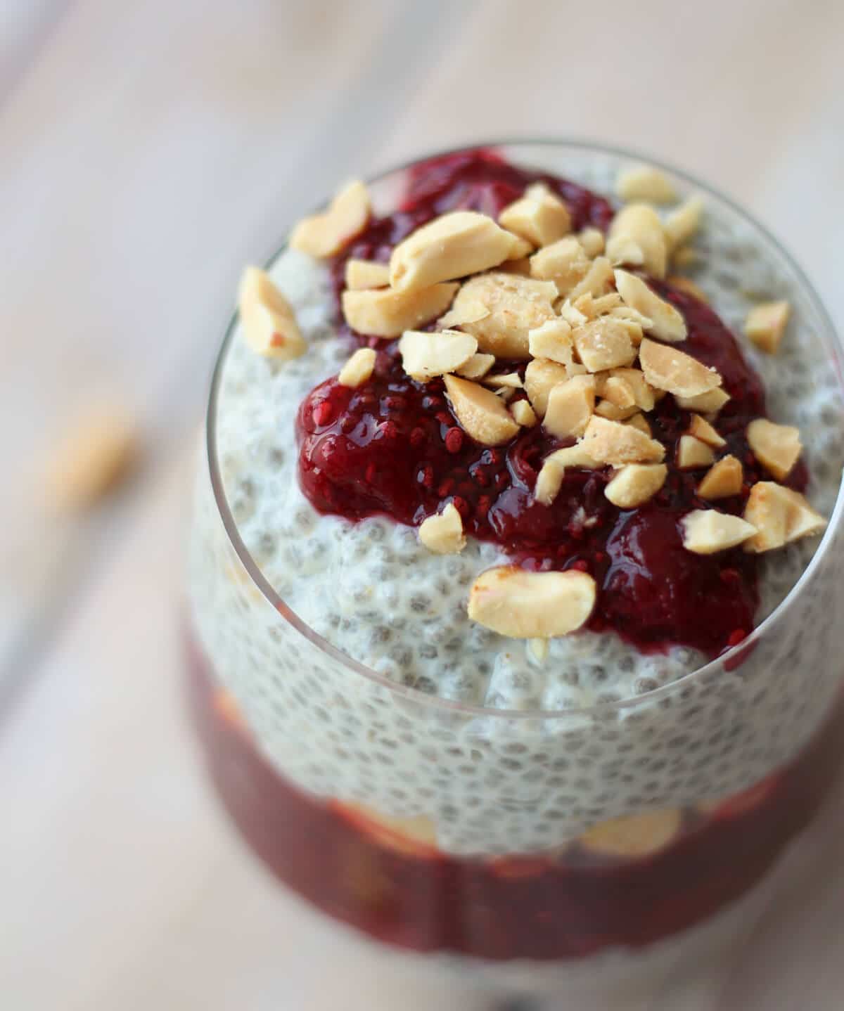 An overhead photo of a container of peanut butter and jam vegan chia pudding.