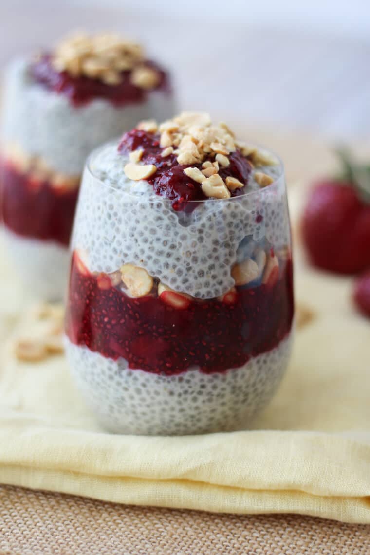 Layers of chia pudding and jam in a glass jar. 