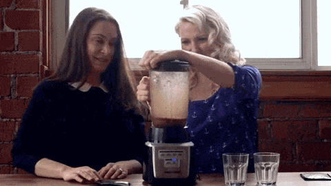 A gif of Abbey Sharp and Abby Langer gagging after drinking a smoothie.