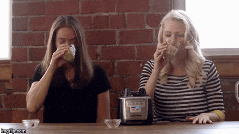 A gif of Abbey Sharp and Abby Langer laughing and gagging after drinking a smoothie.