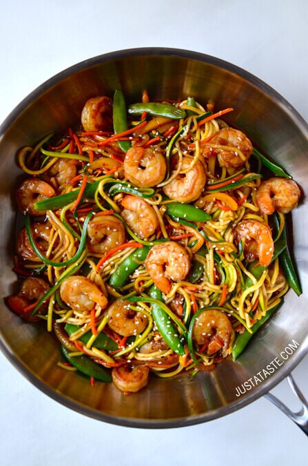 A wok with asian zucchini noodle stir fry with shrimp.