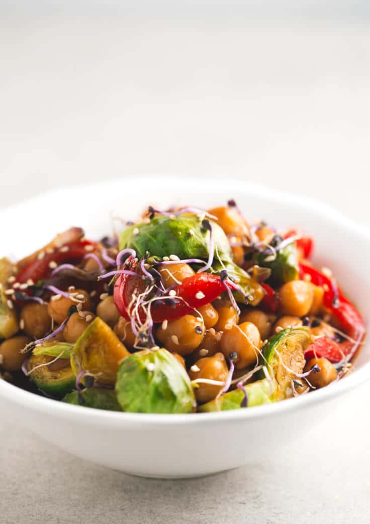 A white bowl with chickpea and vegetable stir fry.