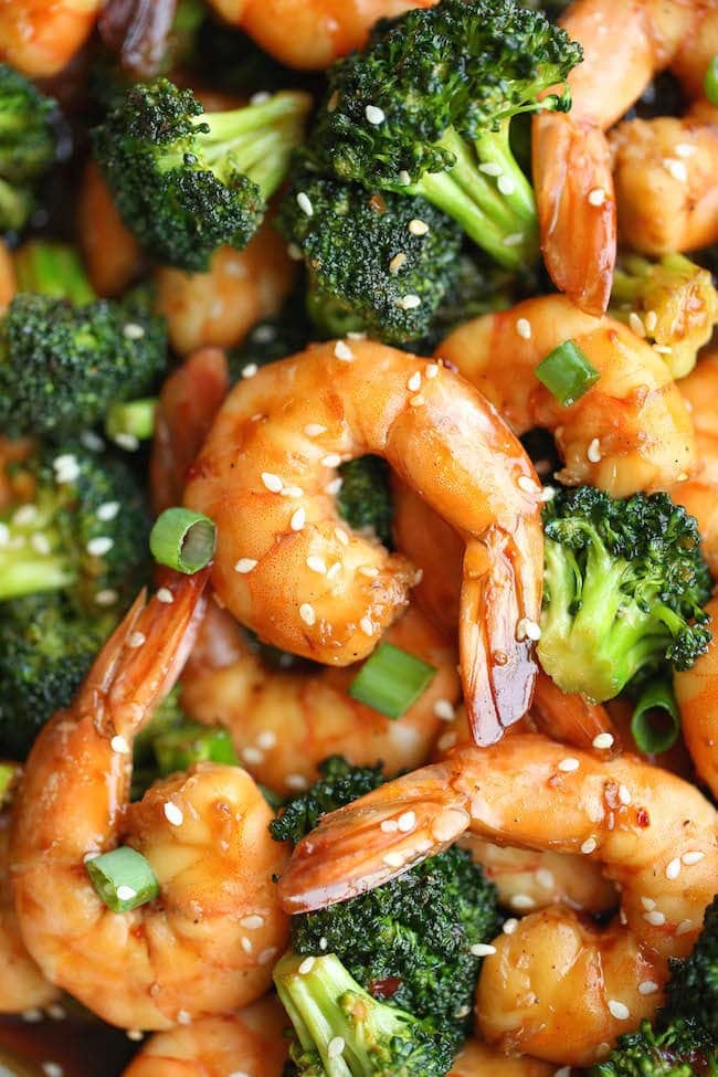 A close up of a shrimp and broccoli stir fry.