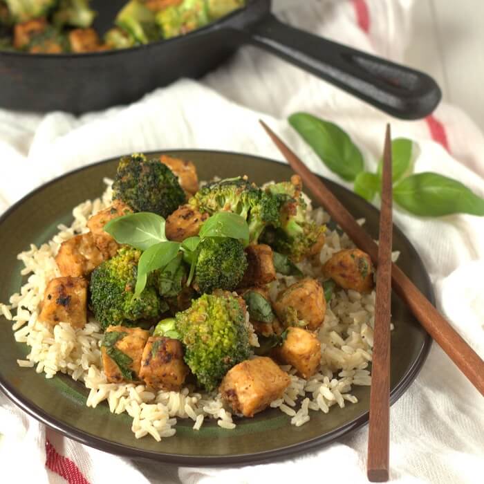 A plate with peanut butter basil tempeh with broccoli.