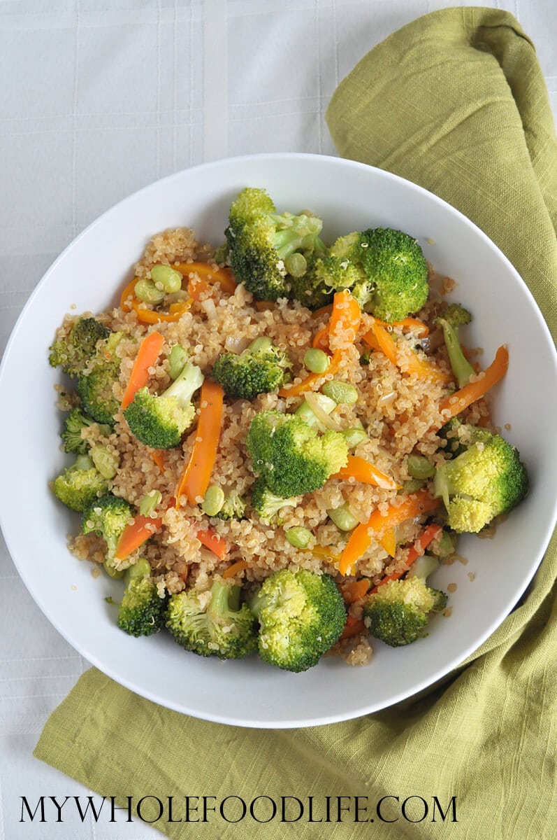 A white bowl with quinoa vegetable stir fry.