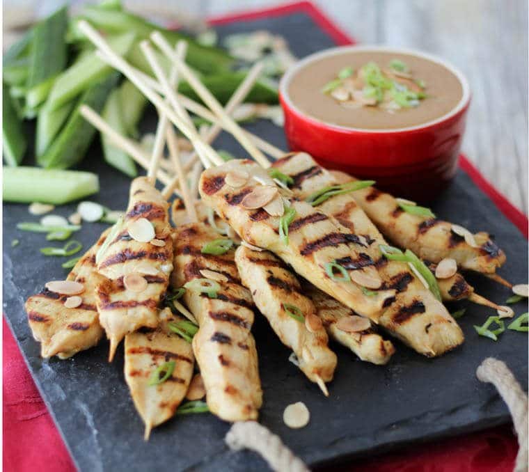 A serving platter with chicken skewers.