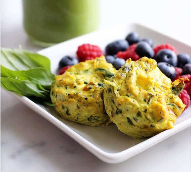 A plate with egg muffins and fruit.