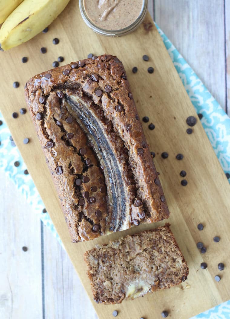 birds eye view of healthy chocolate chip banana bread on a wooden serving dish