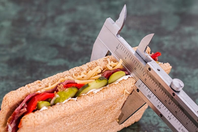 A tool measuring the thickness of a sandwich.