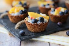 Close up of a granola cup with fruit on top.