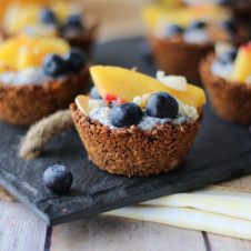 Close up of a granola cup with fruit on top.