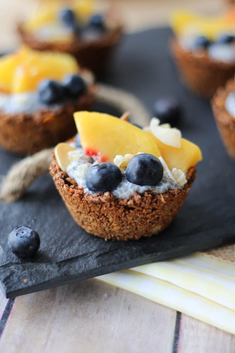 Close up photo of chia pudding granola cups with fresh fruit on top.