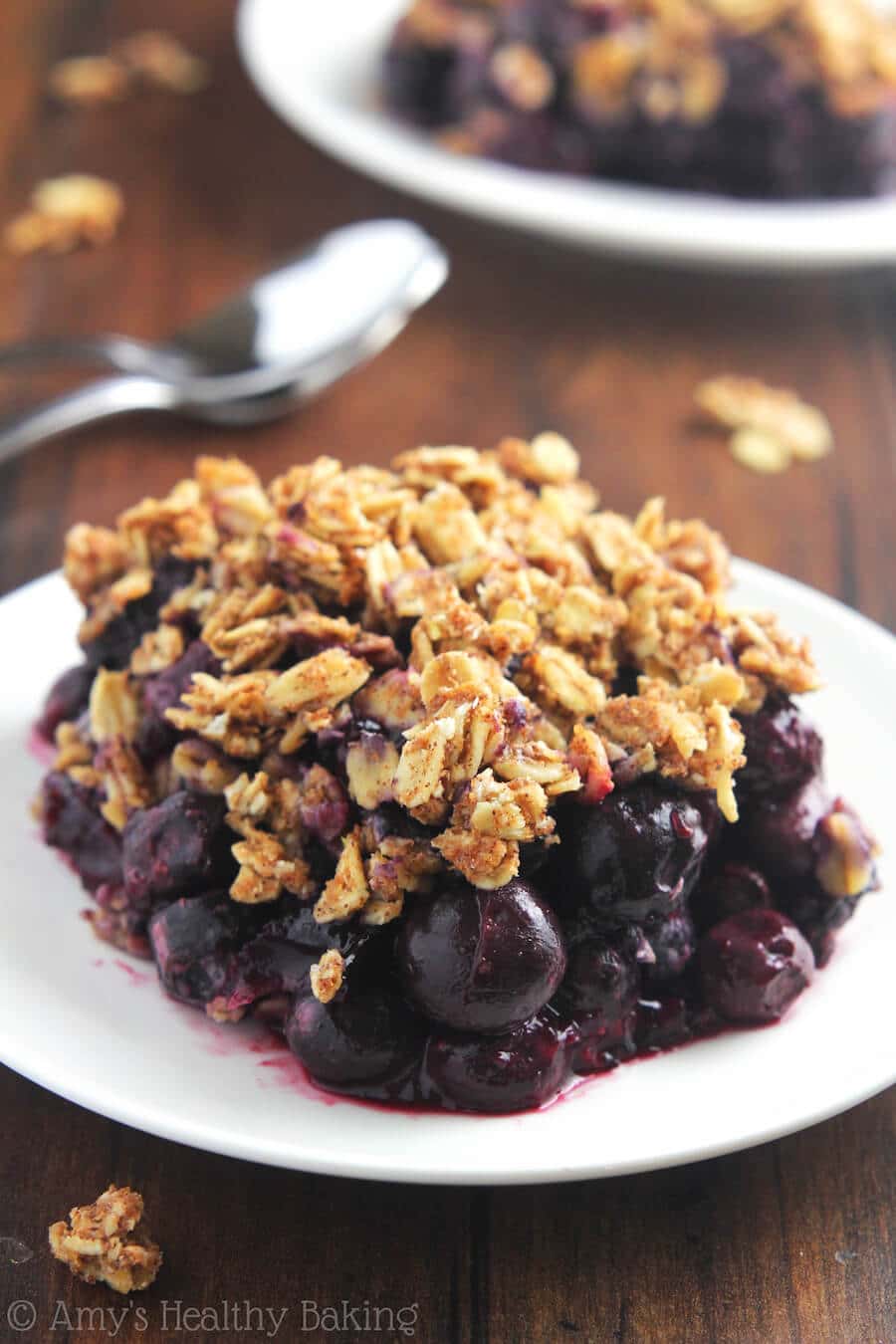 A white plate with blueberry almond crumble.