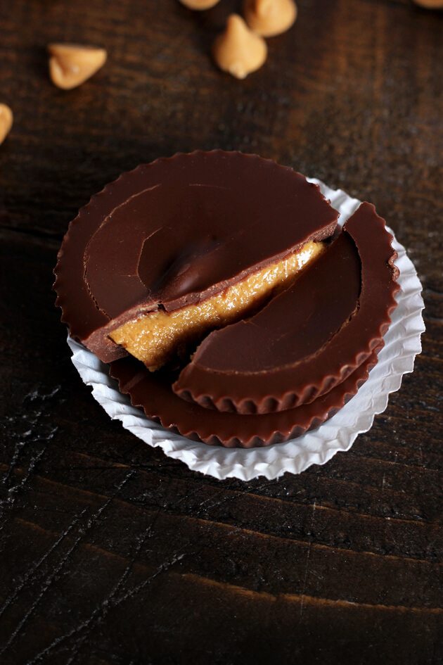 An overhead angled shot of a peanut butter cup split in two.
