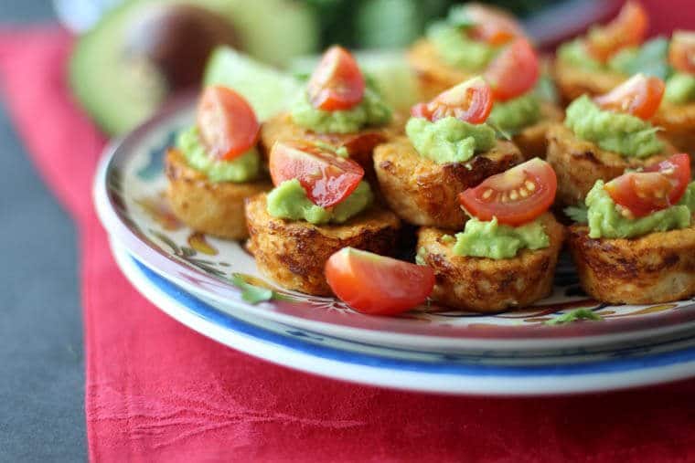 A close up of a plate with multiple Mexican cauliflower mini muffins.