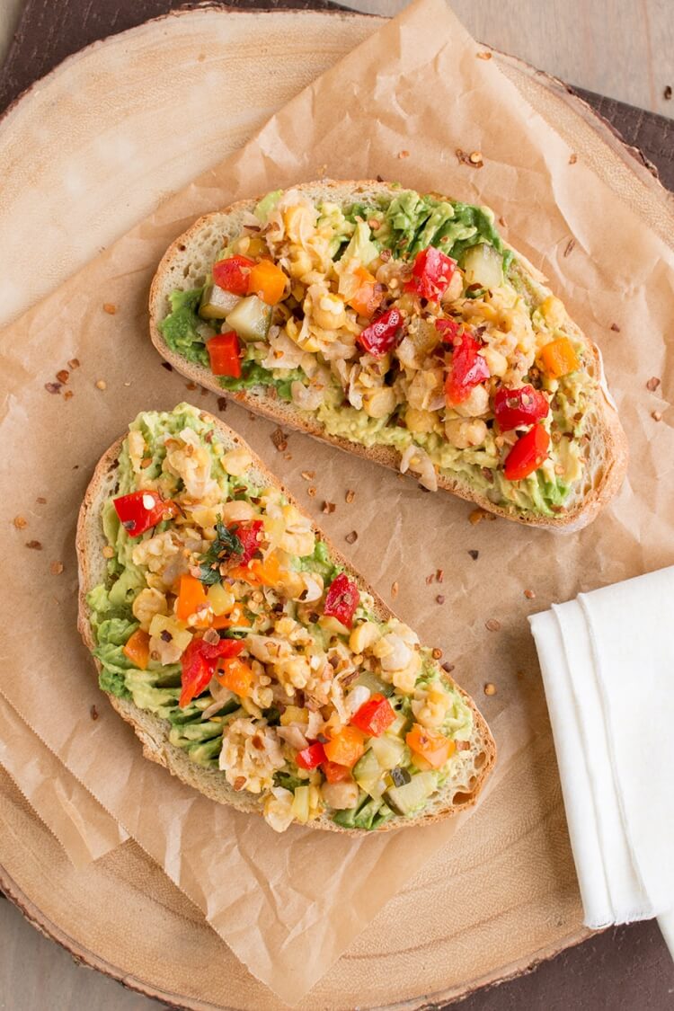 Avocado toast with mashed chickpeas on top.