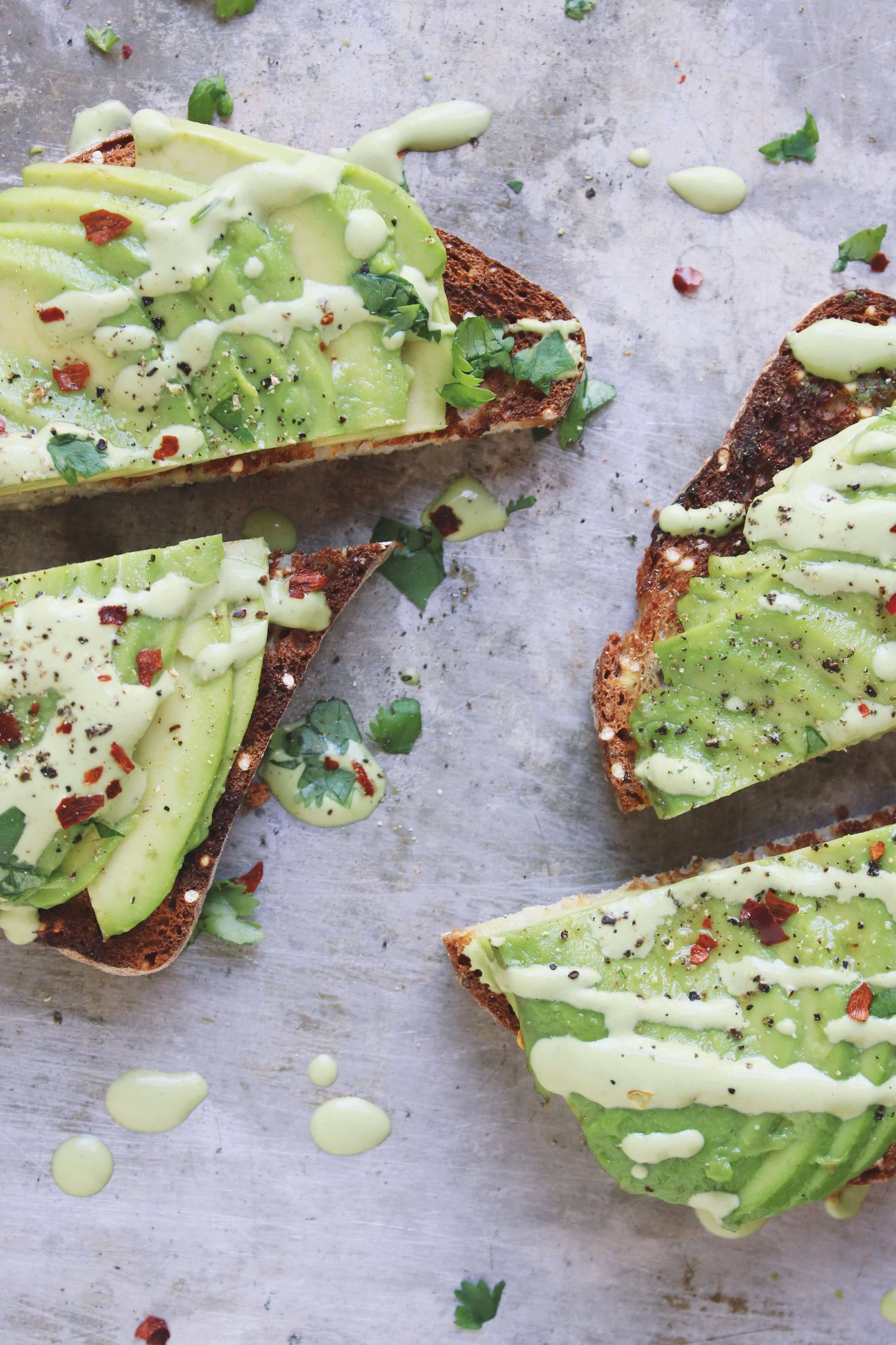 Close up of sliced avocados on toast.