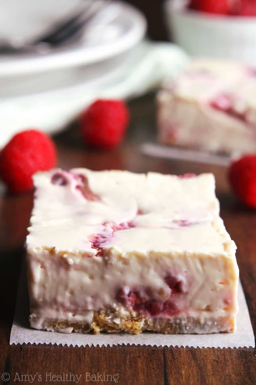 A close up of a raspberry cheesecake bar.