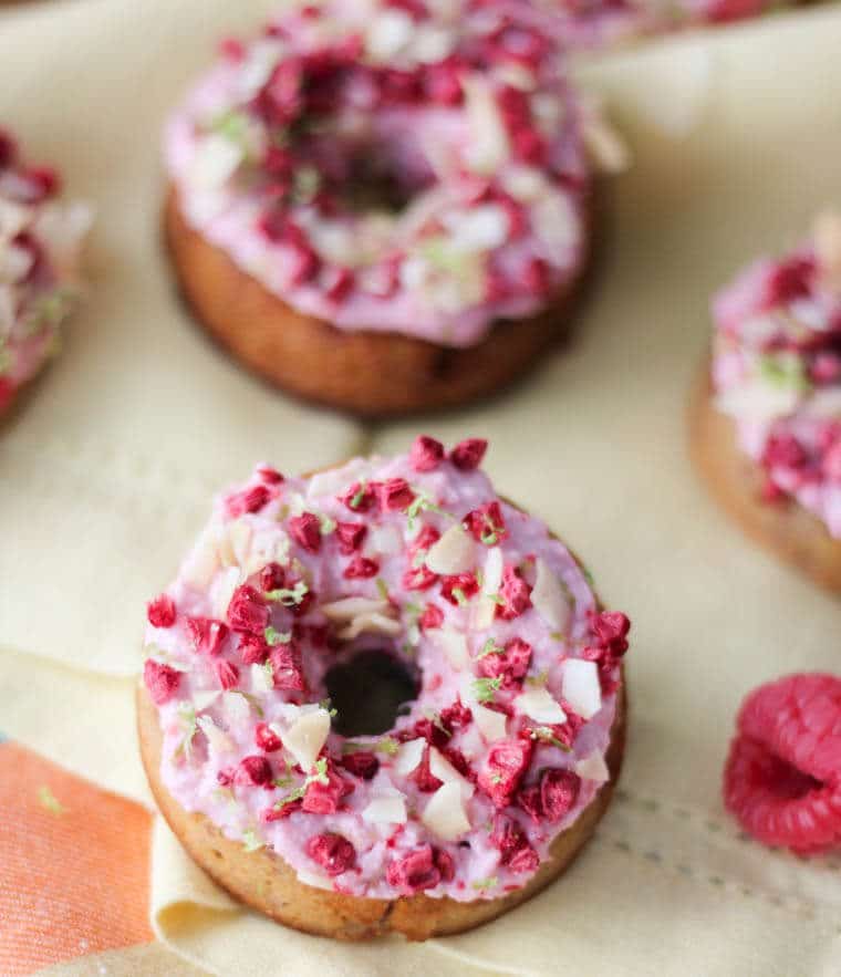 A close up of a raspberry margarita donut.