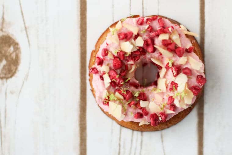 A close up of a raspberry margarita donut.