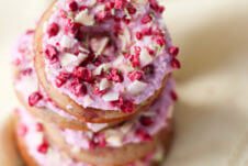 A close up of a stack of raspberry margarita donut.