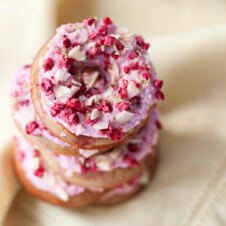 A close up of a stack of raspberry margarita donut.