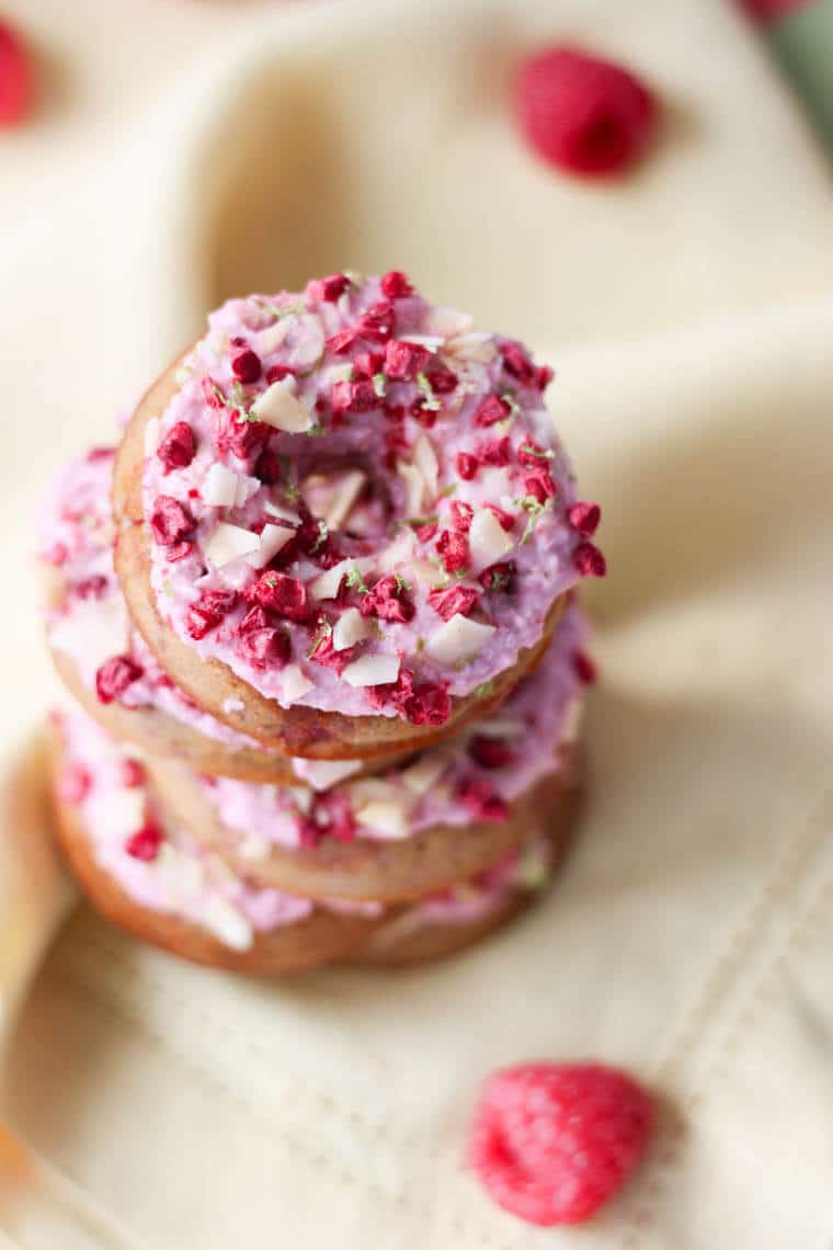 A close up of a stack of raspberry margarita donut.