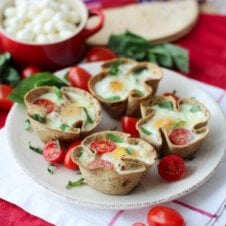 Caprese egg cups on a white plate.
