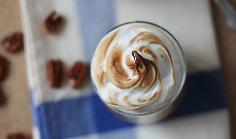 An overhead photo showing toasted meringue topping in a glass cup.