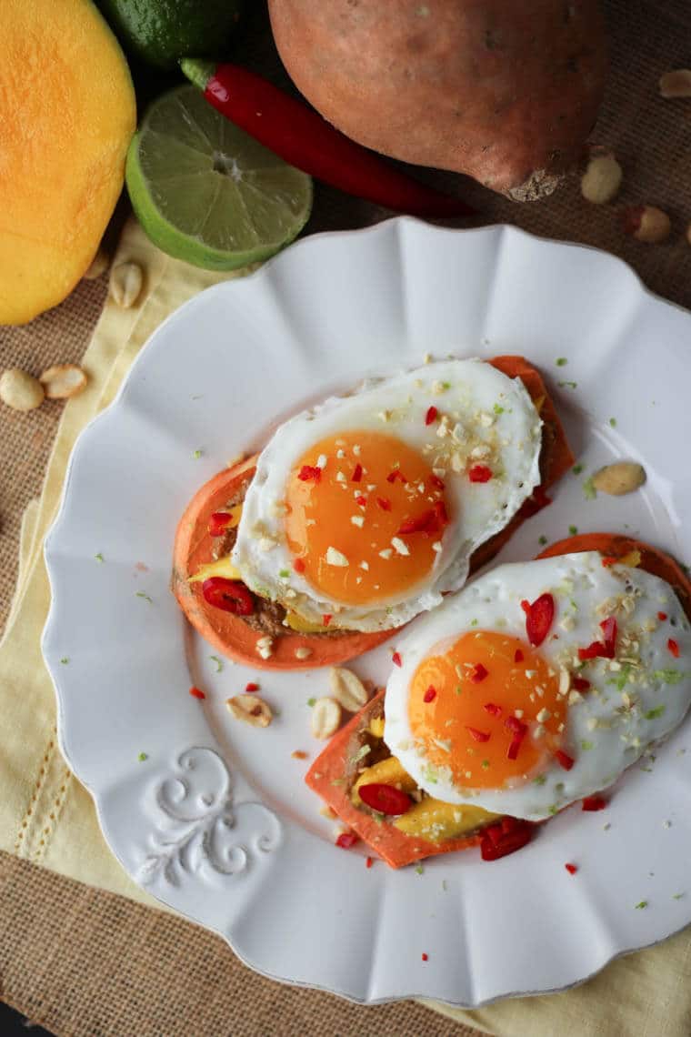 A plate of two sweet potato toast with Thai peanut butter and fried egg.